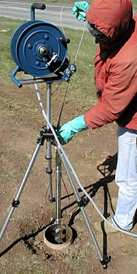 Lowering a borehole video camera into a bedrock monitoring well